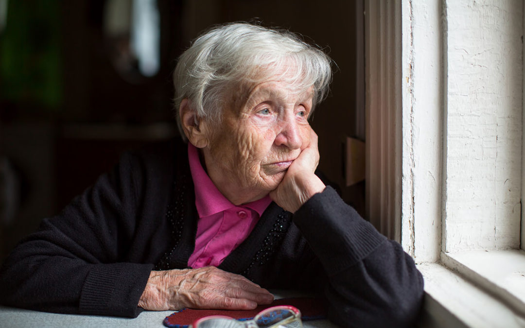Senior with Alzheimers disease looking at the window
