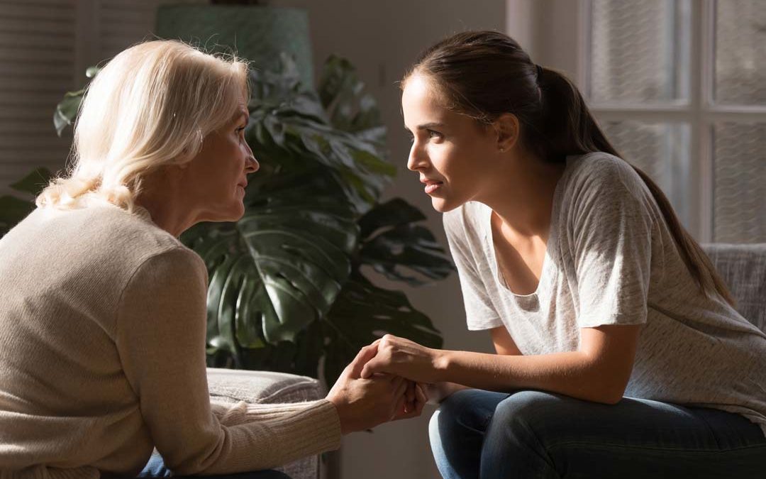 Daughter talking to her mom about moving to assisted living facility